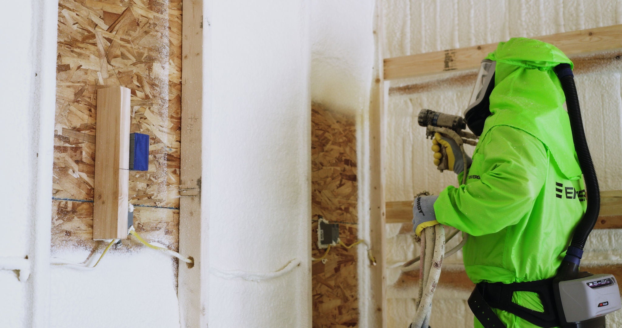 man spraying Enverge NEXSEAL insulation into wall