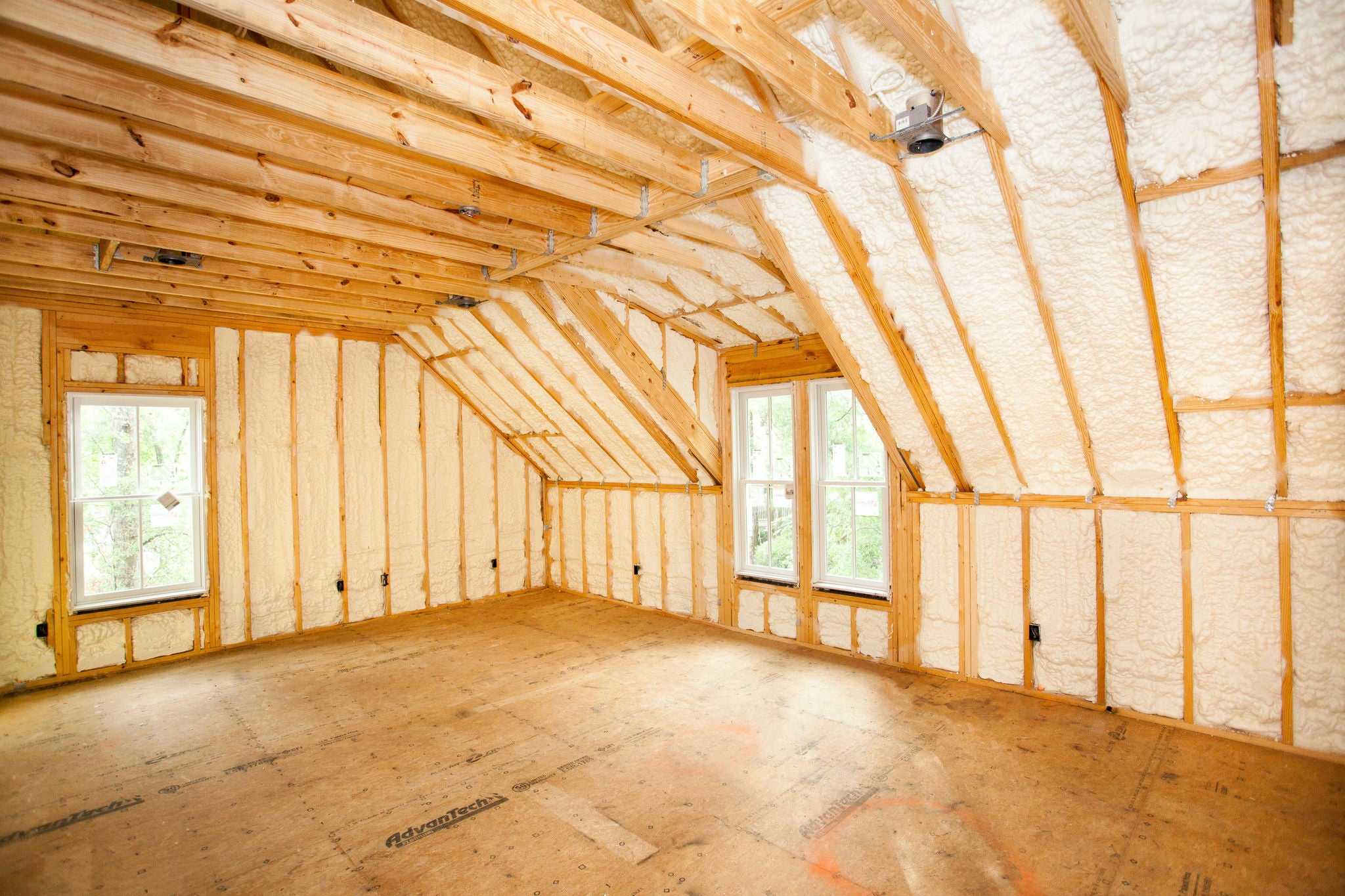 A picture of the interior of a home being built with spray foam insulation in it's walls